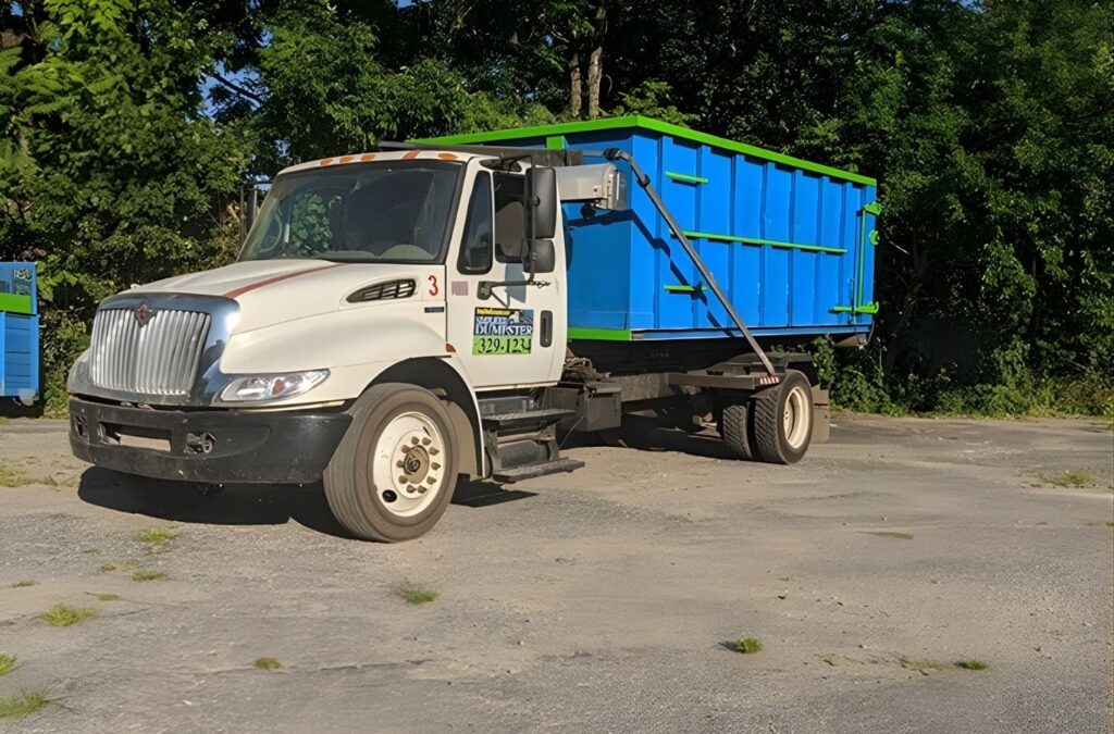 A blue Simplified Dumpster container set beside a Shiawassee County, MI property, showing convenient access for renovation debris and household waste.